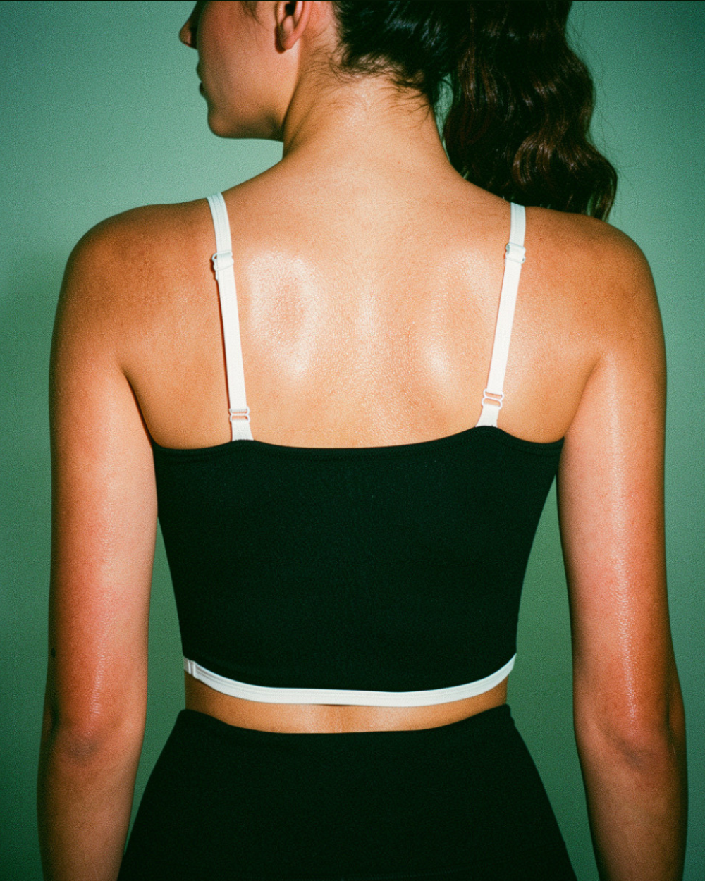 Model Wearing black bralette with white contrast piping detail Back View - Intyra