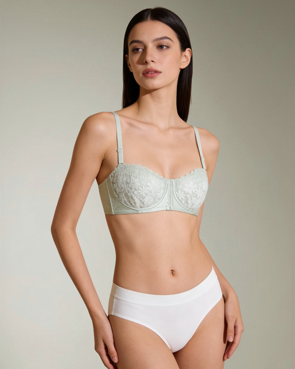 Luxury mint green floral lace bra by Intyra featuring underwired light padded cups, delicate embroidery, and adjustable straps on a model.