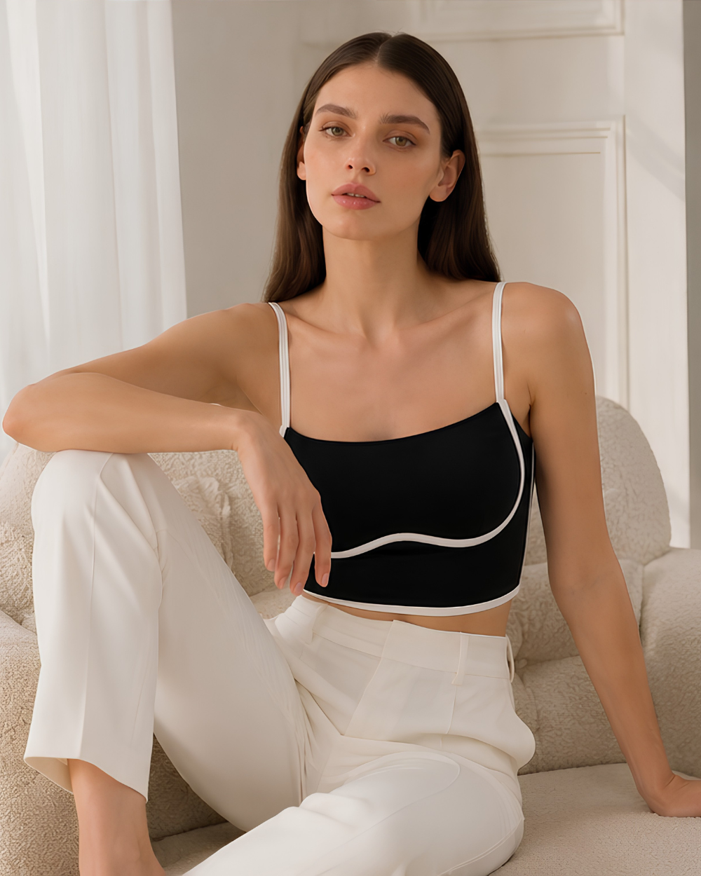Model wearing the Intyra Monochrome Muse Corset Top featuring a square neckline, contrast white piping, and a sculpted black silhouette.