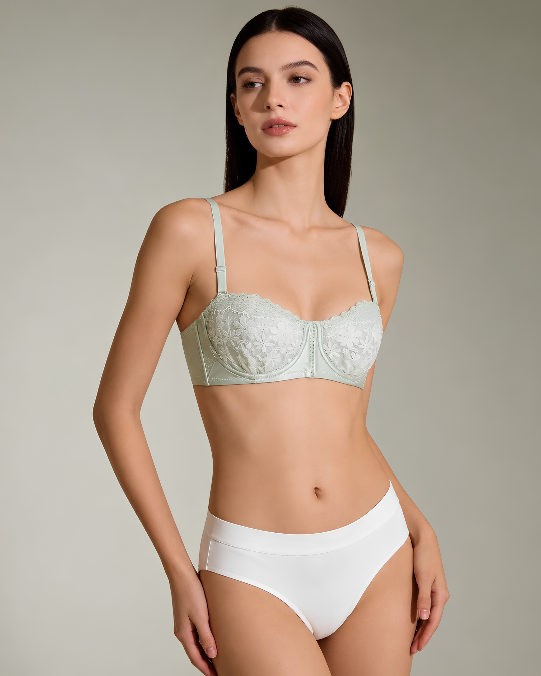 Luxury mint green floral lace bra by Intyra featuring underwired light padded cups, delicate embroidery, and adjustable straps on a model.