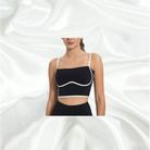 Black padded bra top with white contrast piping, square neckline, ultra-soft non-wired design, full lining, and adjustable straps for a chic and versatile look.