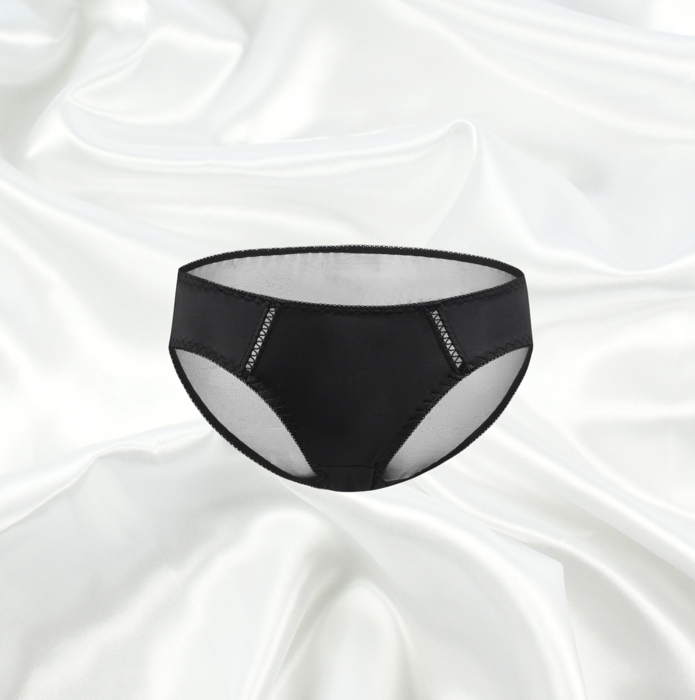 Black sheer bikini brief by Intyra featuring intricate mesh panels and delicate detailing, available in one size