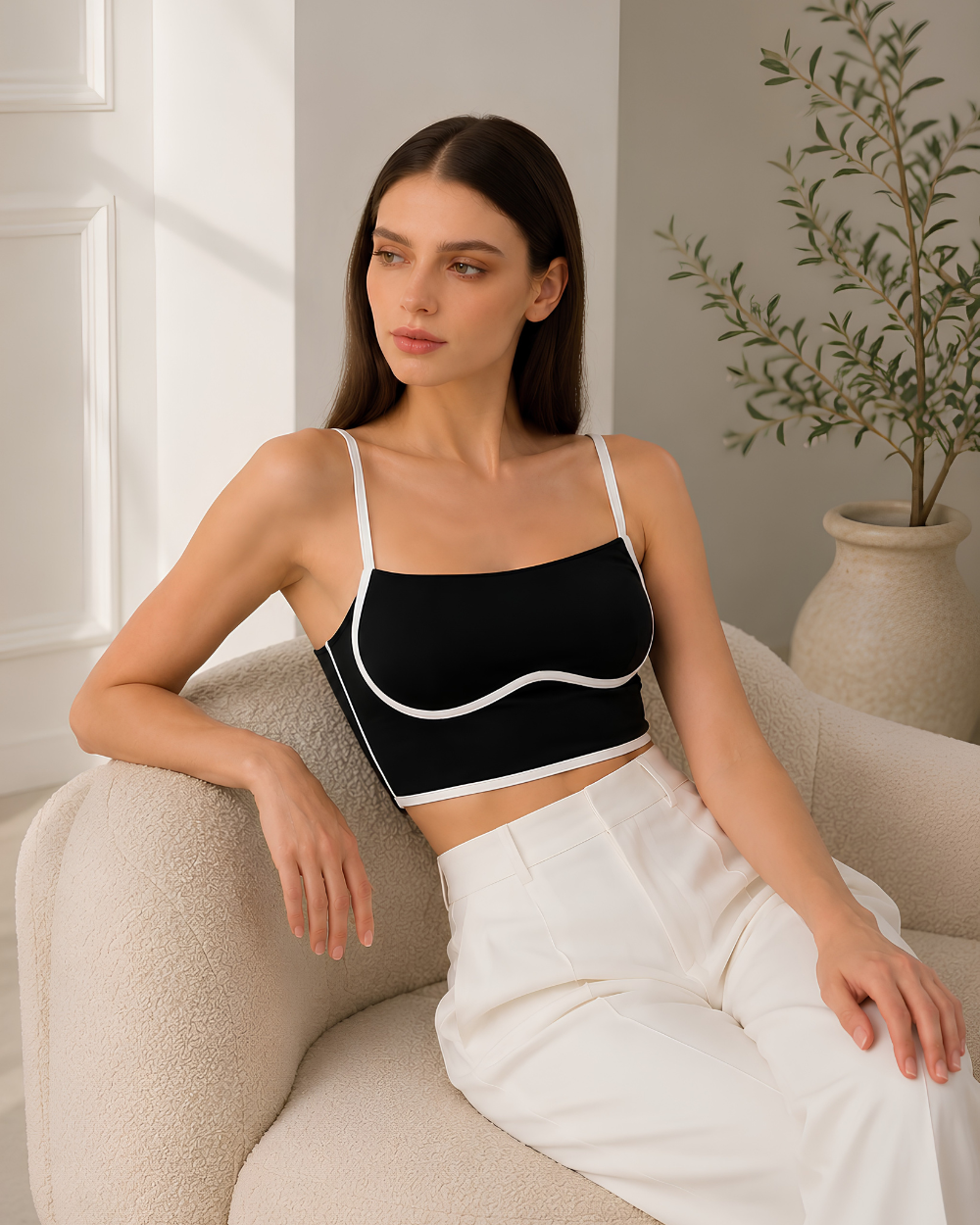 Side profile of model wearing the Intyra Monochrome Muse Corset Top showcasing sculpted contour lines and elegant contrast piping.