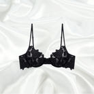 Non-padded black lace bra with underwire support and floral embroidery, paired with matching black embroidered lace panties with scalloped edges for a refined look.