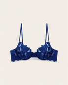 Celeste Azure Balconette Bra featuring sheer embroidered lace and midnight blue floral detailing on a white background.