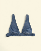 Denim Devil Corset Bra Top in soft-washed denim featuring a sculpted silhouette and plunge neckline on a contrast background.