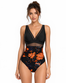 Full View of Model wearing the Flame Orchid One-Piece featuring vibrant floral accents and refined mesh detailing.