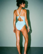 Back profile of the Skyline Tranquility One-Piece Swimsuit with ruched side ties and flattering resortwear silhouette.